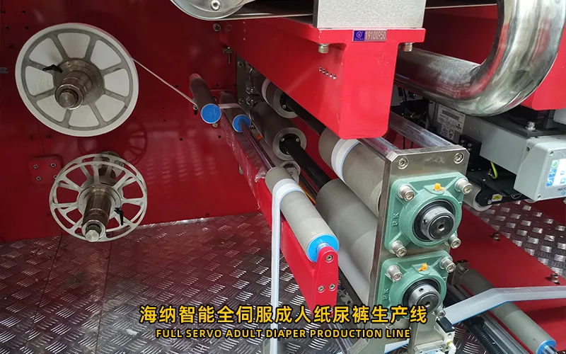 Adult diaper machine core processing and web transfer sections under inspection