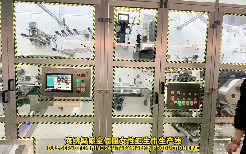 Sanitary napkin line layout with material loading and service areas
